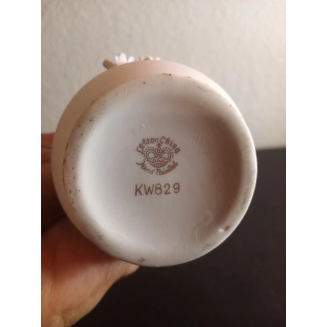 This is a Lefton 6" Bud Porcelain Vase with applied Handle & Florals. Procured at an auction