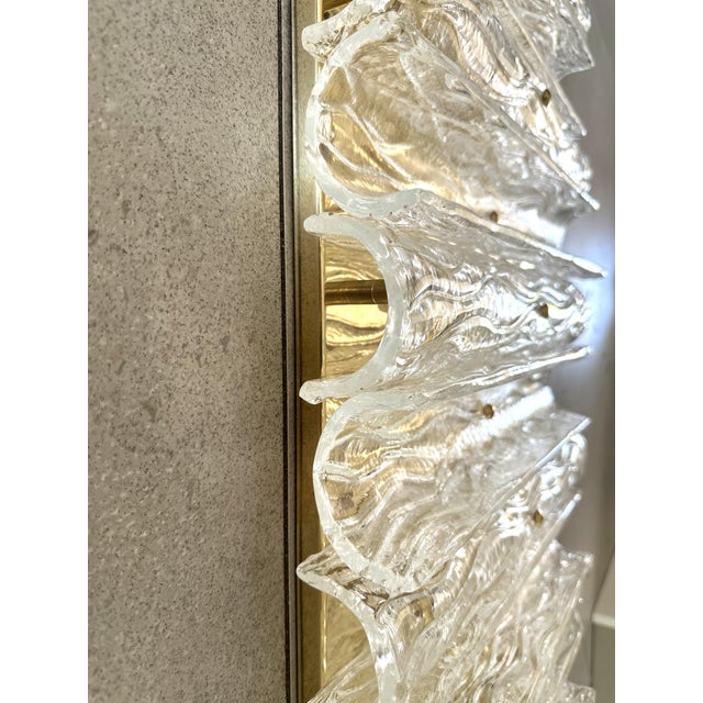 Huge rectangular wall sconce in unlaquered brass and Transparent Murano glass with a partcular shape that give brigtness ....