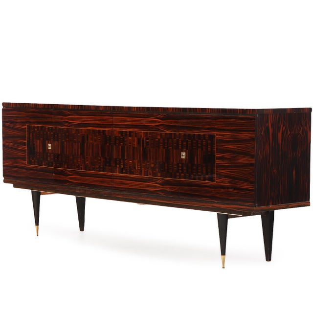An exceptional French Mid-Century Modern Macassar ebony sideboard, circa mid 20th century, showcasing striking horizontal...