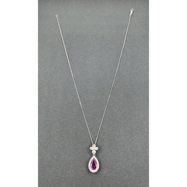 A stunning platinum pendant necklace showcasing modern elegance. This exquisite piece features a 1.97-carat natural pear-...
