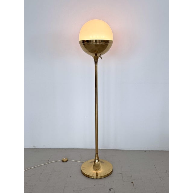 Gorgeous and elegant Mid-Century Modern Brass and large Milk Glass Globe Floor Lamp, designed and manufactured of high...