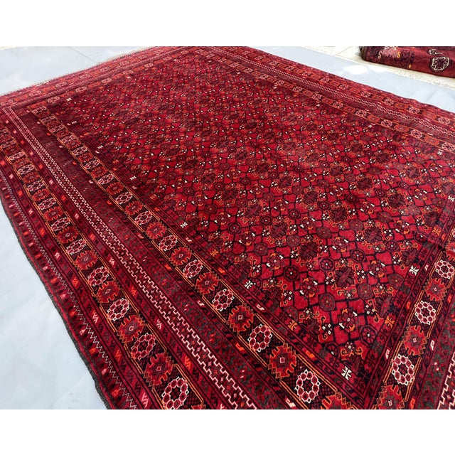 A commanding vintage Afghan Bashiri tribal rug from northern Afghanistan — hundreds of small rounded rosette guls in a...