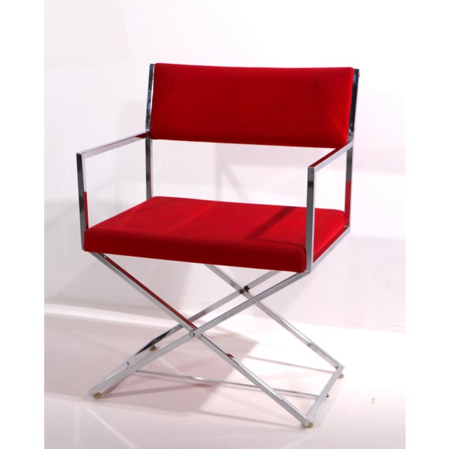 Stunning chrome frame Directors Chair with vibrantly red upholstered seat and backrest. The chair was manufactured by...
