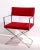 Stunning chrome frame Directors Chair with vibrantly red upholstered seat and backrest. The chair was manufactured by...
