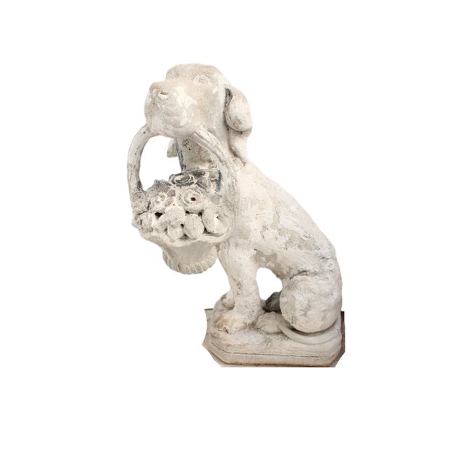 Carved English vintage cast dog sculpture from the mid-20th century carrying a basket of flowers in his mouth. Born in...