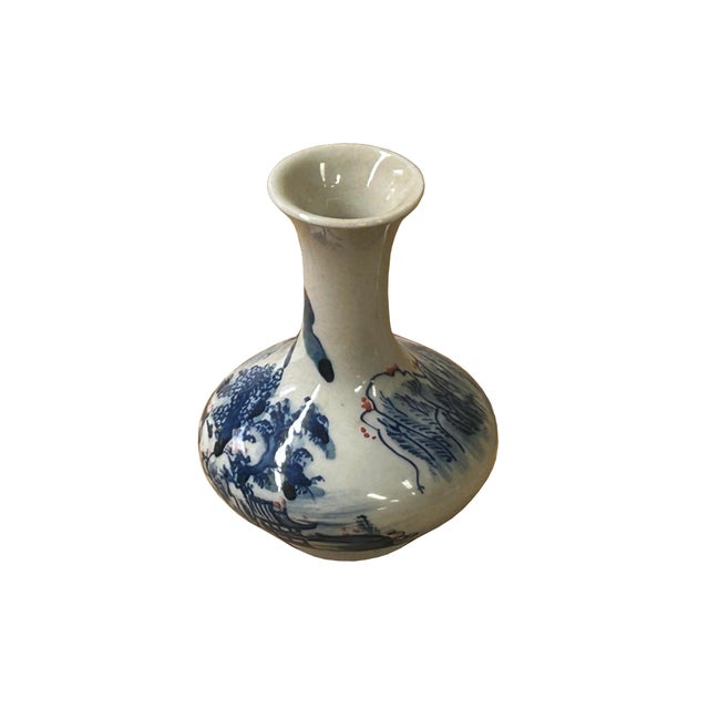 This exquisite small porcelain vase features a classic baluster-style silhouette with a gracefully flared rim and a...