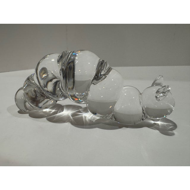 Sculptural clear crystal glass caterpillar paperweight formed from a series of rounded, polished segments with a detailed...