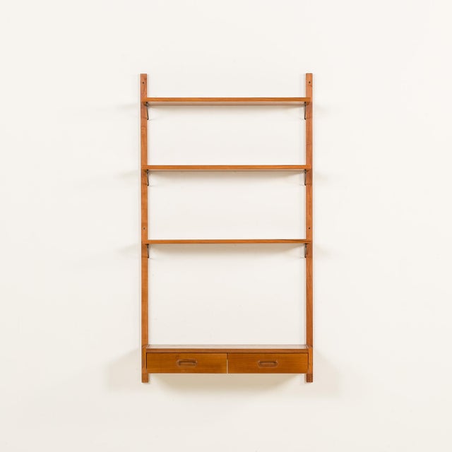 This scandinavian vintage wall unit in teak was made in denmark sometime in the 1970s. the overall set size is h: 150 / w:...