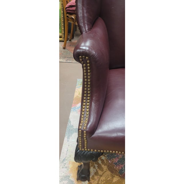Fine Antique burgundy leather Chippendale Wing chair. Features 19th century claw and ball foot frame, leather upholstery...