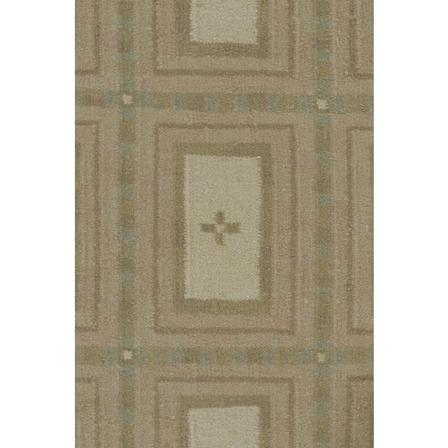 This 8x10 Scandinavian rug presents an elegant layout of paneled geometric motifs arranged in a disciplined grid....