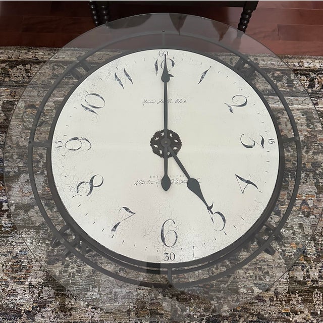 Furnish your space with the Ravenna clock table. It has a decorative metal base, antique dial, and glass top for...