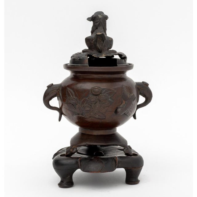 Chinese Patinated Bronze Tripod Censer, together with fitted carved wood base, the cover with foo lion finial, the vessel...