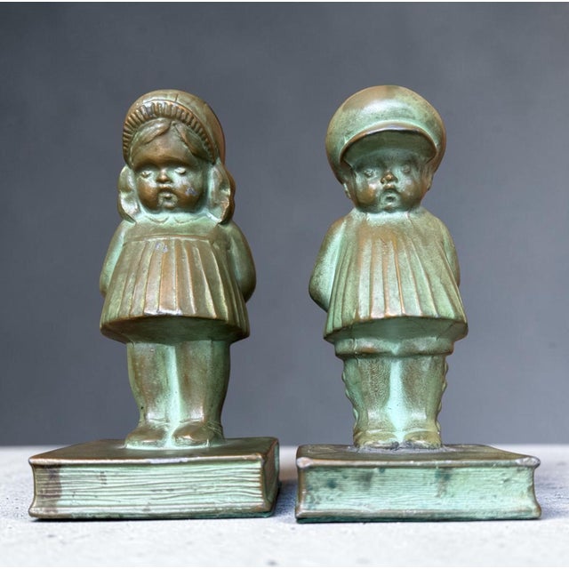 A charming pair of antique bronze bookends with a beautiful verdigris patina— the kind of warm, aged surface that only...