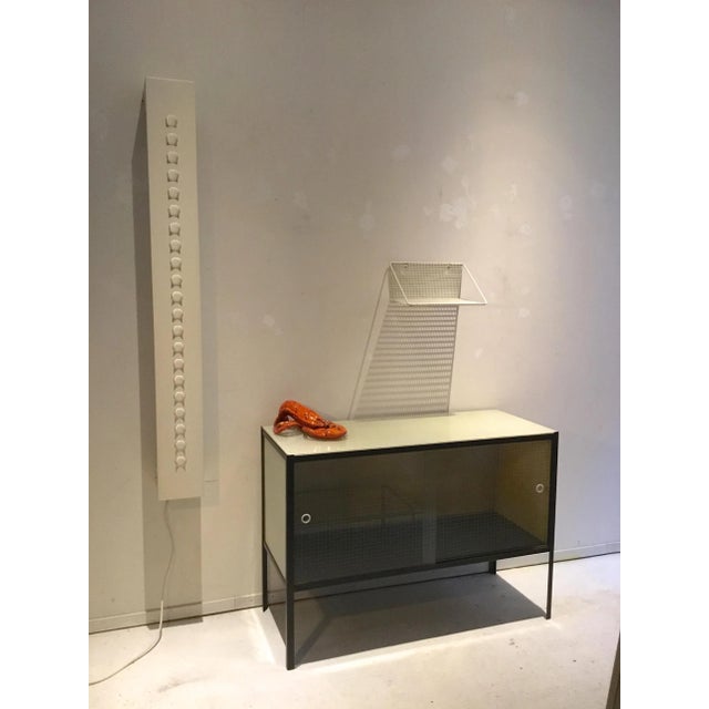 The lamp is painted in white and was originally grey. The TL tube on the inside can be used horizontally and vertically. I...