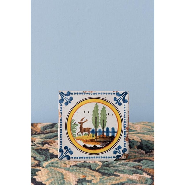 Rosette tile dimensions: 11 x 11 cm Deer tile dimensions: 11.3 x 11.3 cm A loss to lower right corner of deer tile....