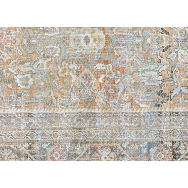 This antique rug originates from the Mahal region of Iran, handwoven using time-honored techniques refined over centuries....