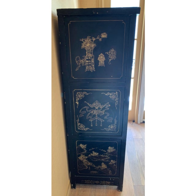 Antique Chinese black lacquer cabinet with ornate paint and inlay depicting a scene of country side living and decorative...