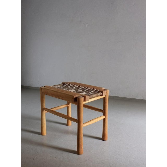 Vintage carved wood stool with a woven seat. I have 3 more items with a lacquered wood surface.