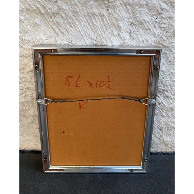 Vintage geometric print on foil paper manufactured in the United Kingdom. The print is housed in a metal frame under glass...