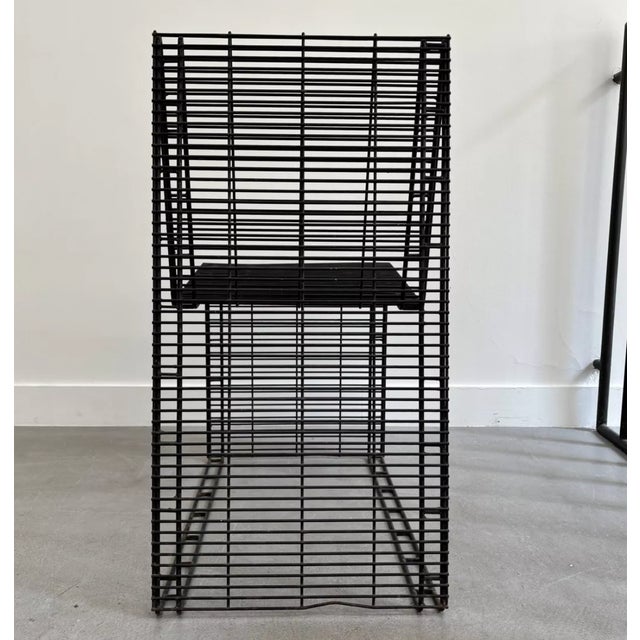 Graphic metal armchair. Made of a very rigid single-piece mesh. In good condition, black with some rust (see photos).