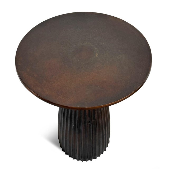 Modern industrial style round cast aluminum side table with antiqued bronze finish. Fluted pedestal base. Each table will...