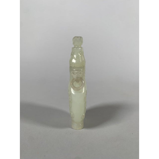 SMALL WHITE NEPHRITE JADE GU VASE, China, Qing Dynasty, Qianlong Period (1736-1795). Finely carved with two taotie masks...