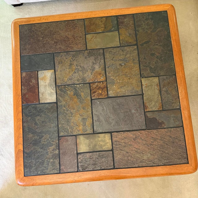 Chic, vintage Sallingboe coffee table with a geometric slate inlay top mounted in a thick teak wood frame, resting on a...