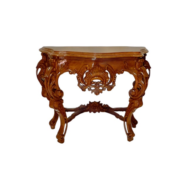 Beautifully and intricately carved wood console table in a Rococo style. Carved shell, floral and foliage motifs. Gorgeous...