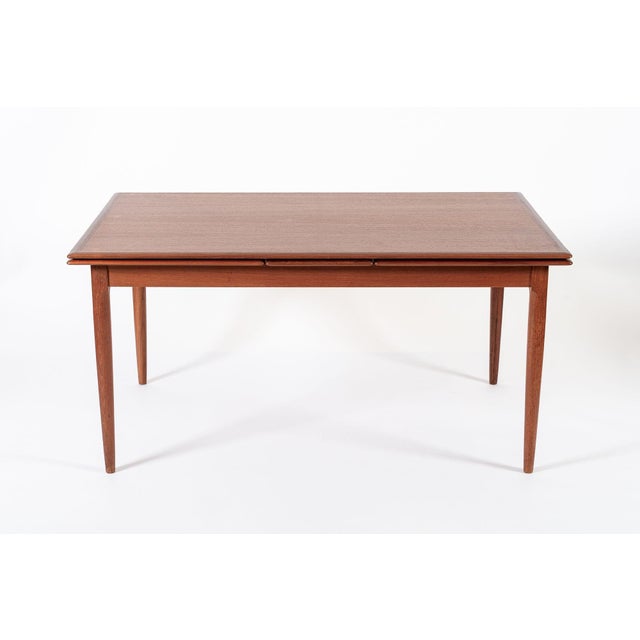 This exceptional vintage mid century Danish modern extendable teak dining table was designed by Kai Kristiansen for Korup...