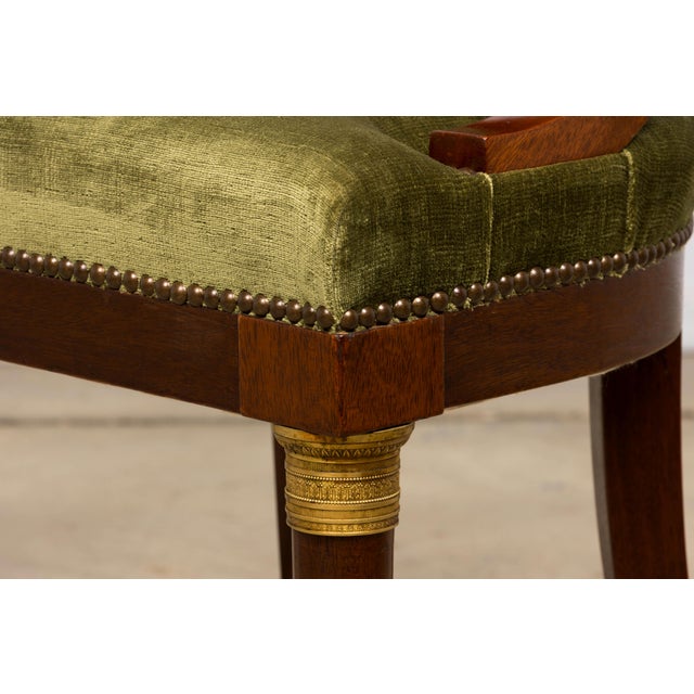 An elegant set of eight early 19th-century French Empire gondola dining chairs, sourced in Paris, France. Crafted in...