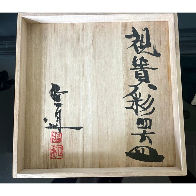 A ceramic square plate with white-celadon glaze by Japanese potter Yoshikawa Masamichi (1946-). The sharp-edged plate...