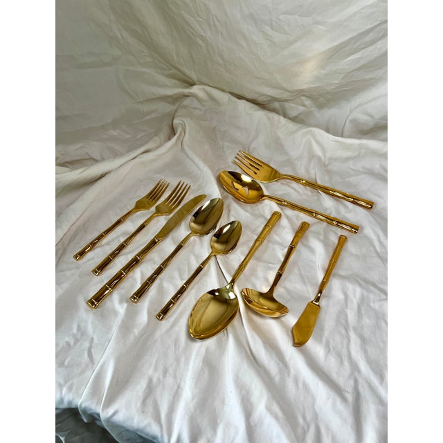Truly a rare set of gold-plated stainless steel flatware from the 1960s. A complete 6-pieces silverware set of eight, with...