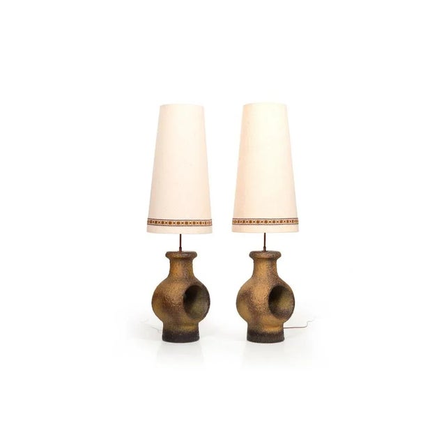 Pair of late 1960s Danish ceramic lamps. They can be used as table - or as floor lamps. With fabric lampshades. European...