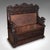 This is an antique baronial settle. A Scottish, carved oak reception hall bench with storage, dating to the Victorian...