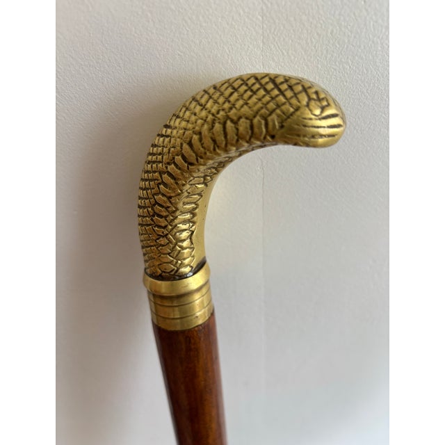 Handsome figural snake-head walking cane. Lovely solid brass and wood with time-worn appeal. Perfect for your dapper...