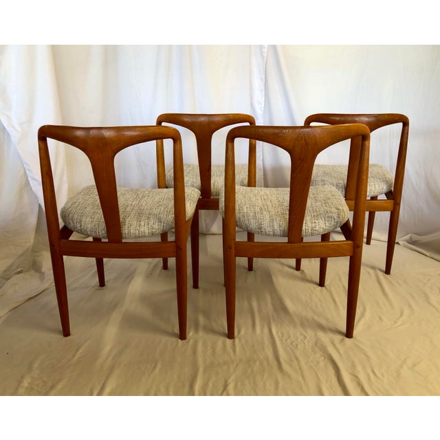 (8) Juliane style teak dining chairs. The design is attributed to Johannes Anderson. The chairs were made for D-Scan. They...