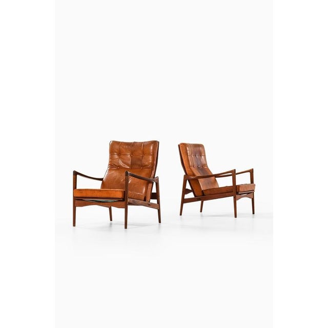 This rare pair of easy chairs, model örenäs, was designed by danish architect and furniture designer ib kofod-larsen and...