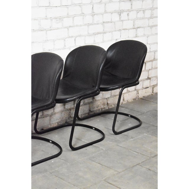 Vintage dining room chairs by Gastone Rinaldi for Thema, Italy. Set consists of 4 chairs with black metal frames and...