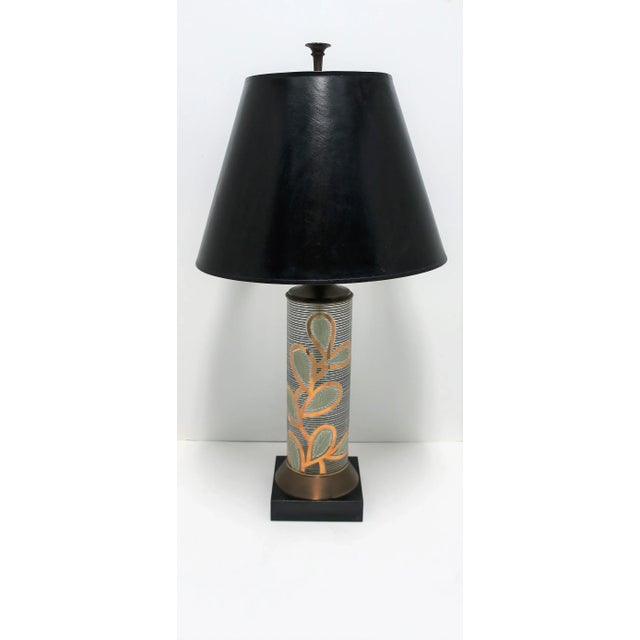 A very beautiful, tall, glass and brass lamp with an organic modern design in black and gold, Midcentury Modern period,...
