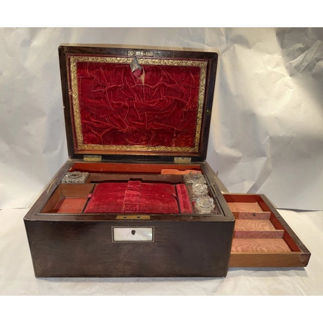 This listing is for an antique English writing or sewing box. It features mother of pearl inlay and a hidden compartment....