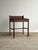 Early oak schoolhouse writing desk with a hinged slant-front lid and open interior storage beneath. Built with the simple,...