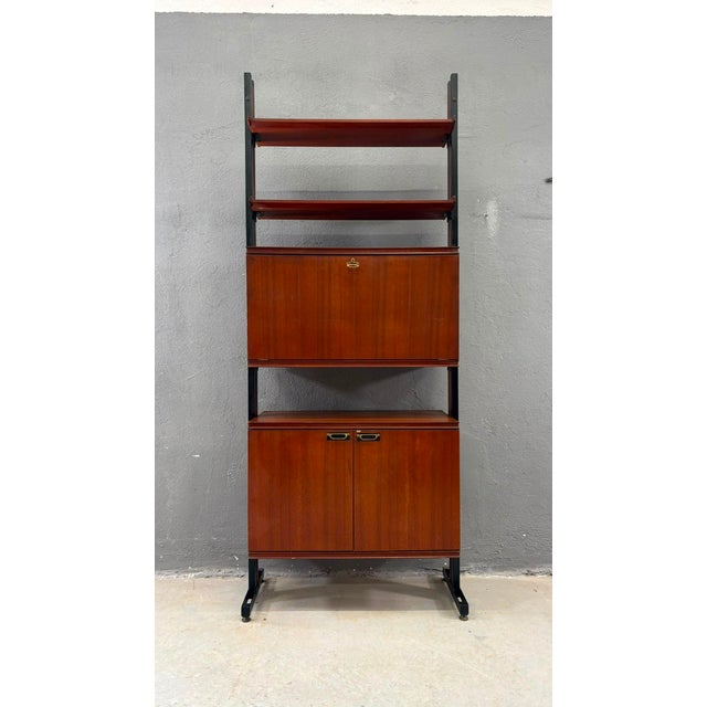 This elegant mid-century modern modular wall unit combines warm veneer cabinetry with a minimalist black metal frame....