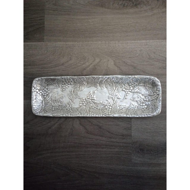 This is a rectangular serving tray original from Mexico. Vintage condition, artisanal, silver color detailed relief of...