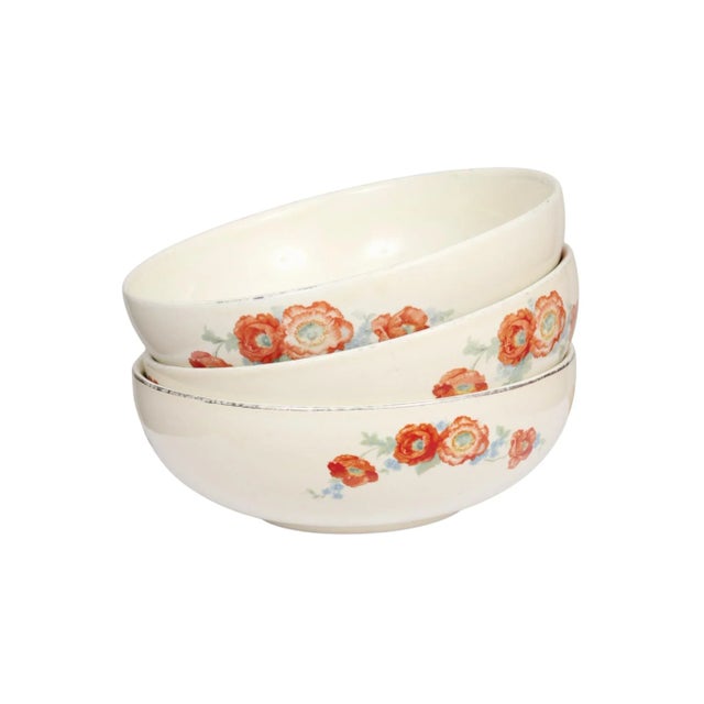 A set of three 1940’s ‘Orange Poppy’ ceramic bowls made by Hall China Company. Each bowl is decorated with a vibrant...