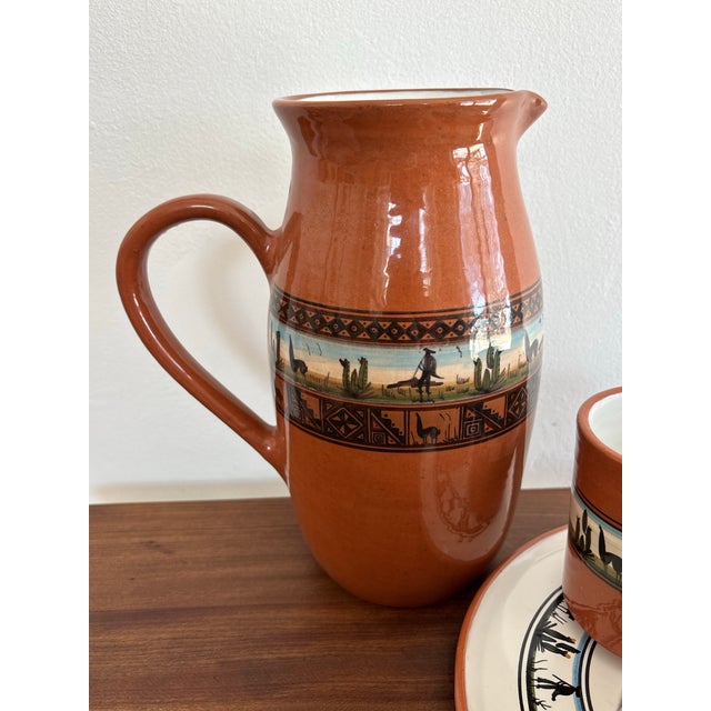 Artisanal studio pottery set, made in Peru. Includes a pitcher, three mugs, and a serving plate. Hand painted with a...
