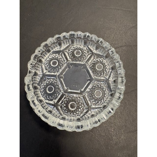 This mid-century Italian pressed glass ashtray, crafted in the 1950s–1960s, showcases a crisp geometric composition with a...