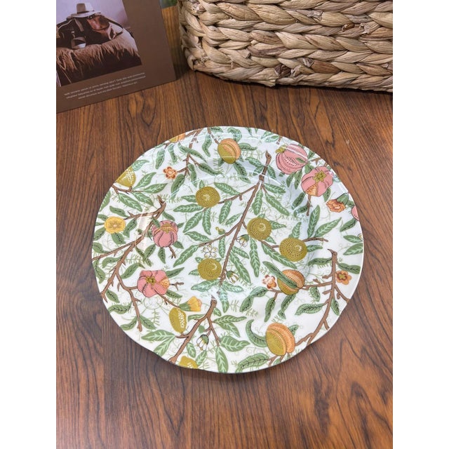 This is a set of four ceramic plates featuring exquisite floral patterns. These plates are a wonderful way to add color...