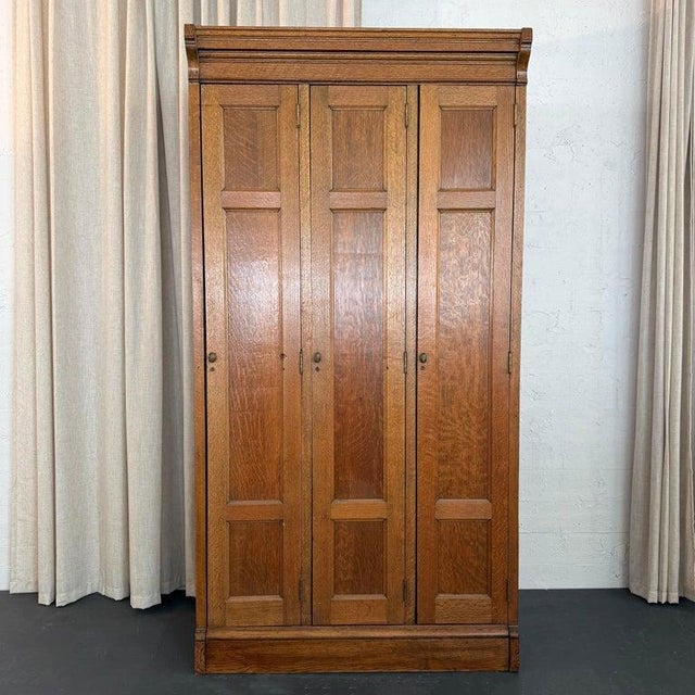 This Late Victorian, Eastlake period three part oak lockers wardrobe cabinet is circa 1880s. The lockers are a beautifully...