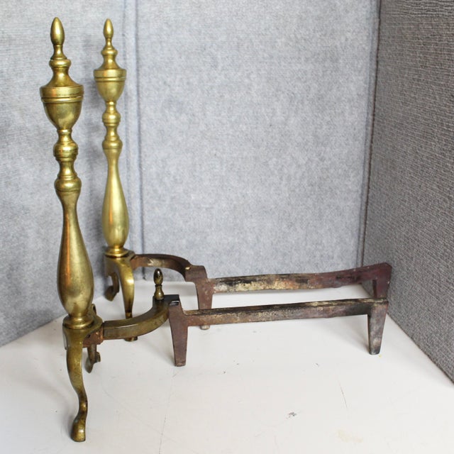 This pair of vintage fireplace andirons are crafted in a traditional Colonial Revival style, these andirons feature brass...