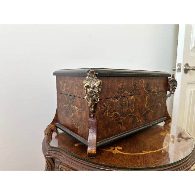 Aries motif storage box. Large decorative box with two ram heads sentinels at each front corner. In a burlwood, faux inlay...